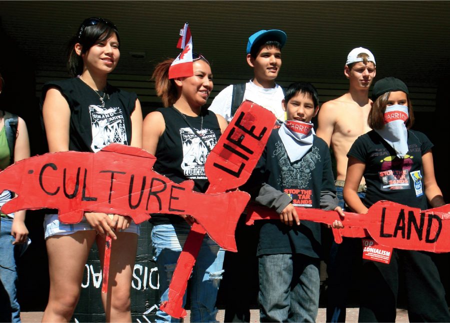 Teens holding red signs reading 