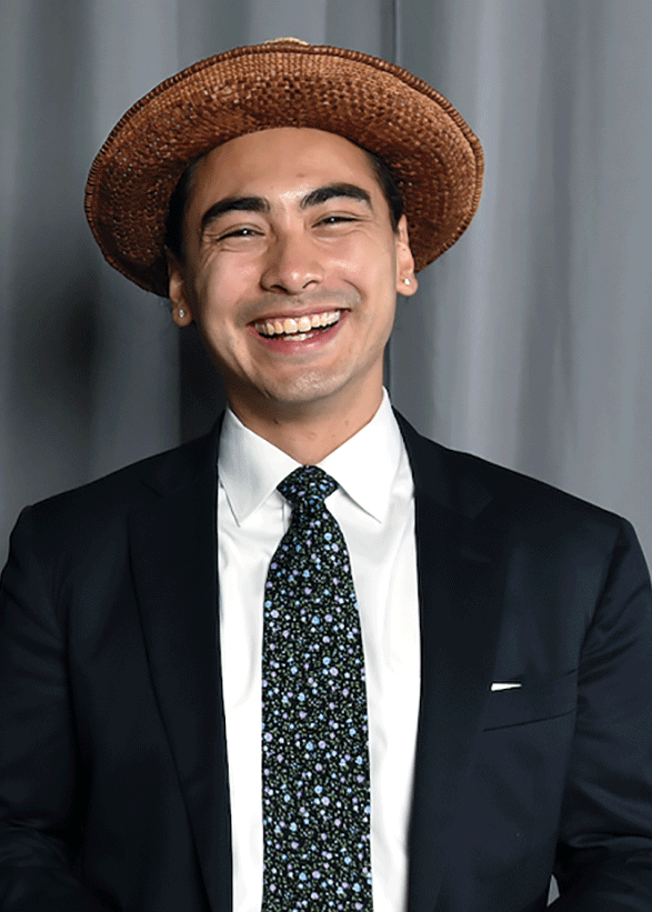 man in a suit and brown hat smiling