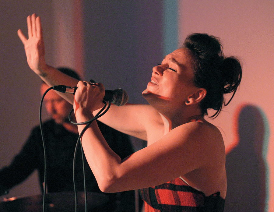 A girl holds a microphone and sings