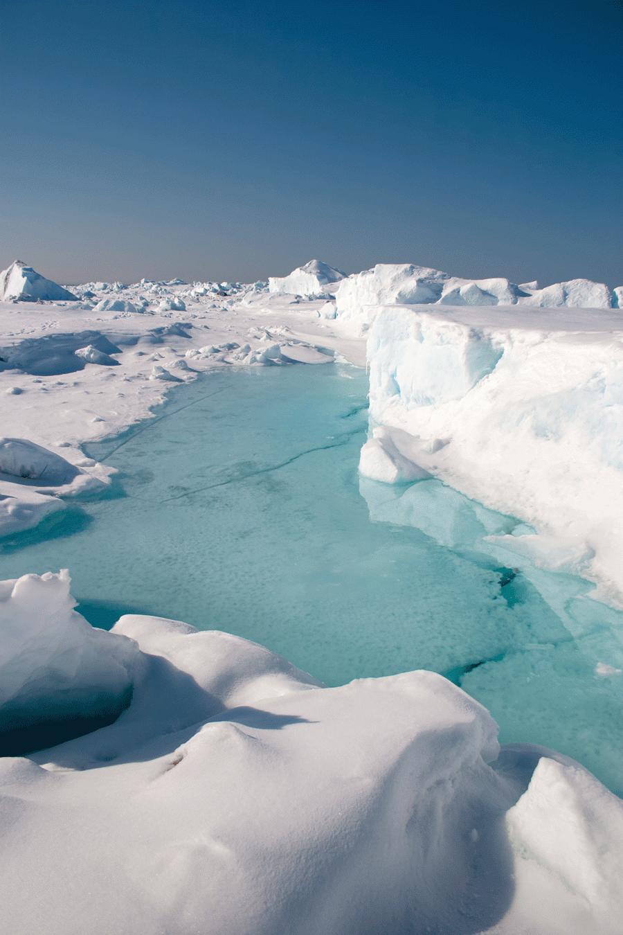 Ice formations surround a turquoise pond